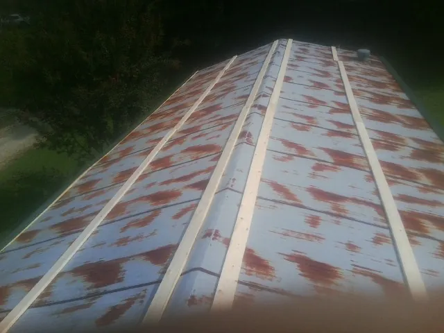Rusted metal roof panels with new wood purlins before replacement — Storm Damage Roof Repair in Woodhaven by Roofing Brothers